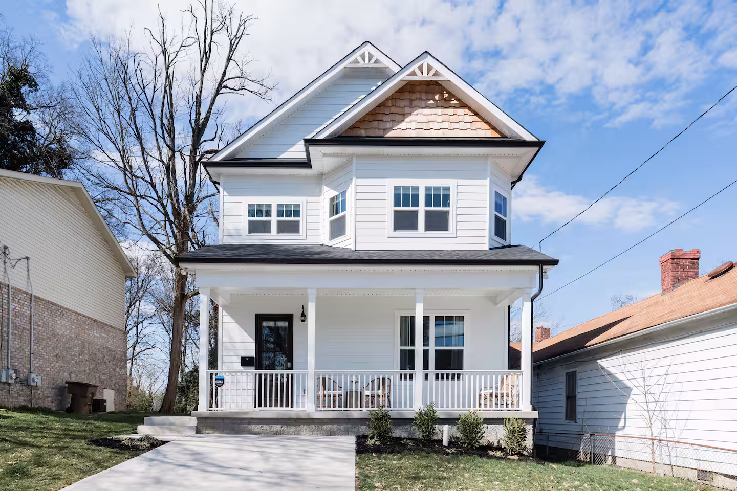 The front of 1602 Meharry Blvd, a white two-story home with a covered porch, built in 2018