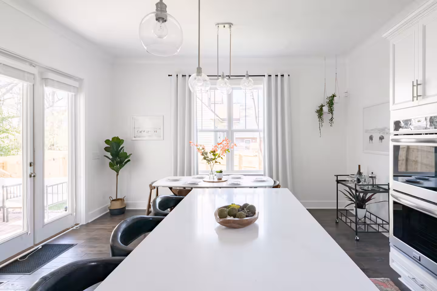 The eat-in kitchen and dining table seen from the living room